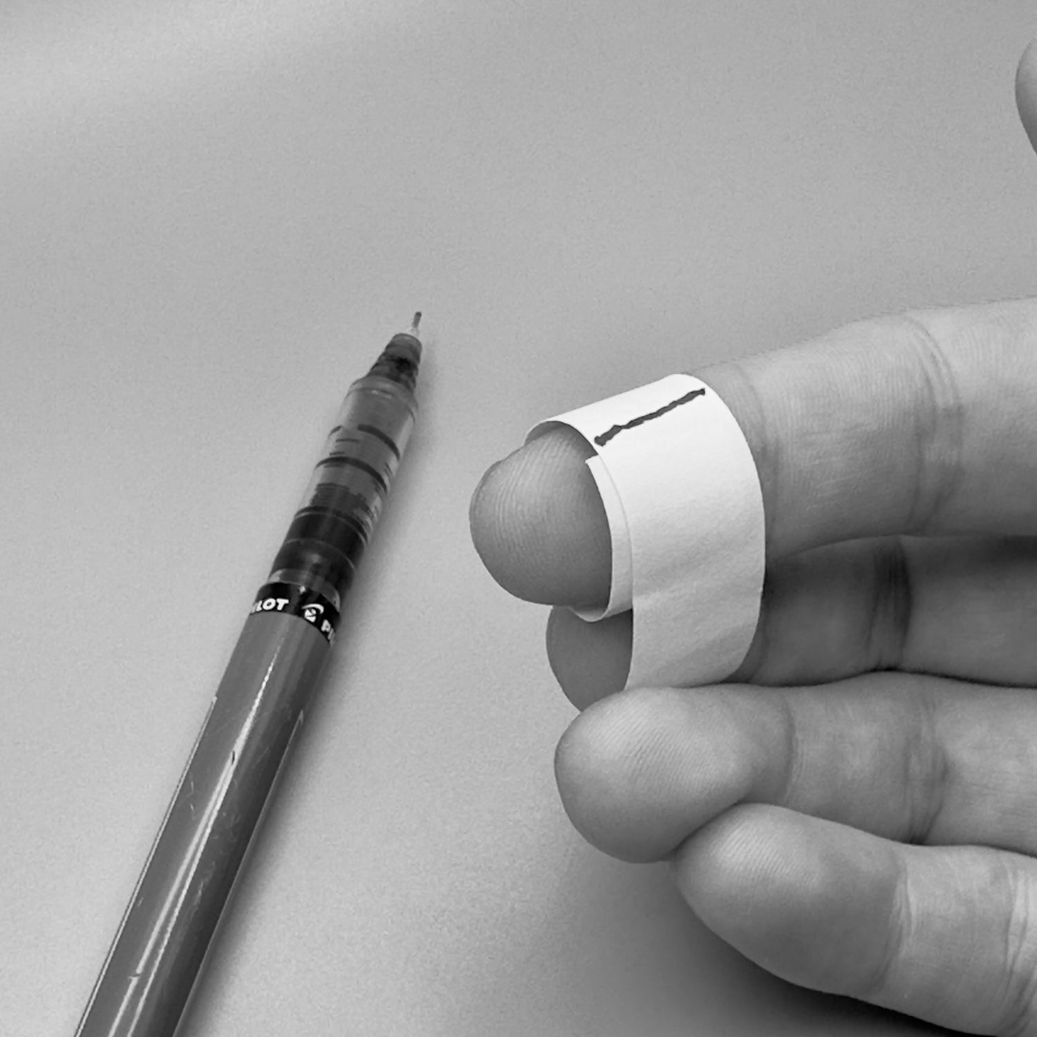 strip of paper wrapped around finger marking the circumference of finger