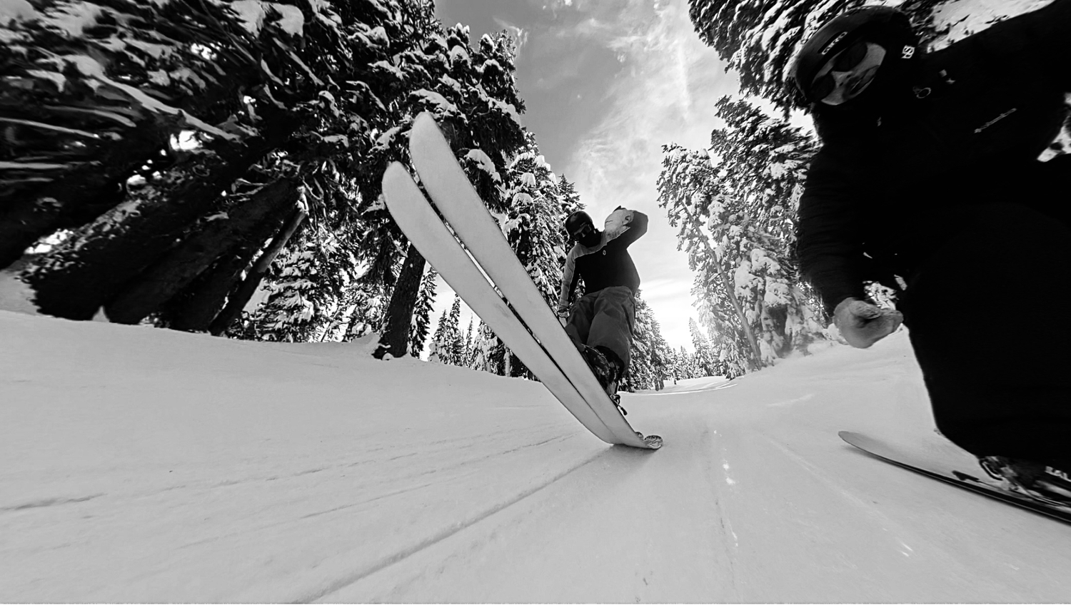 Black and white photo of Evan and Austn skiing.