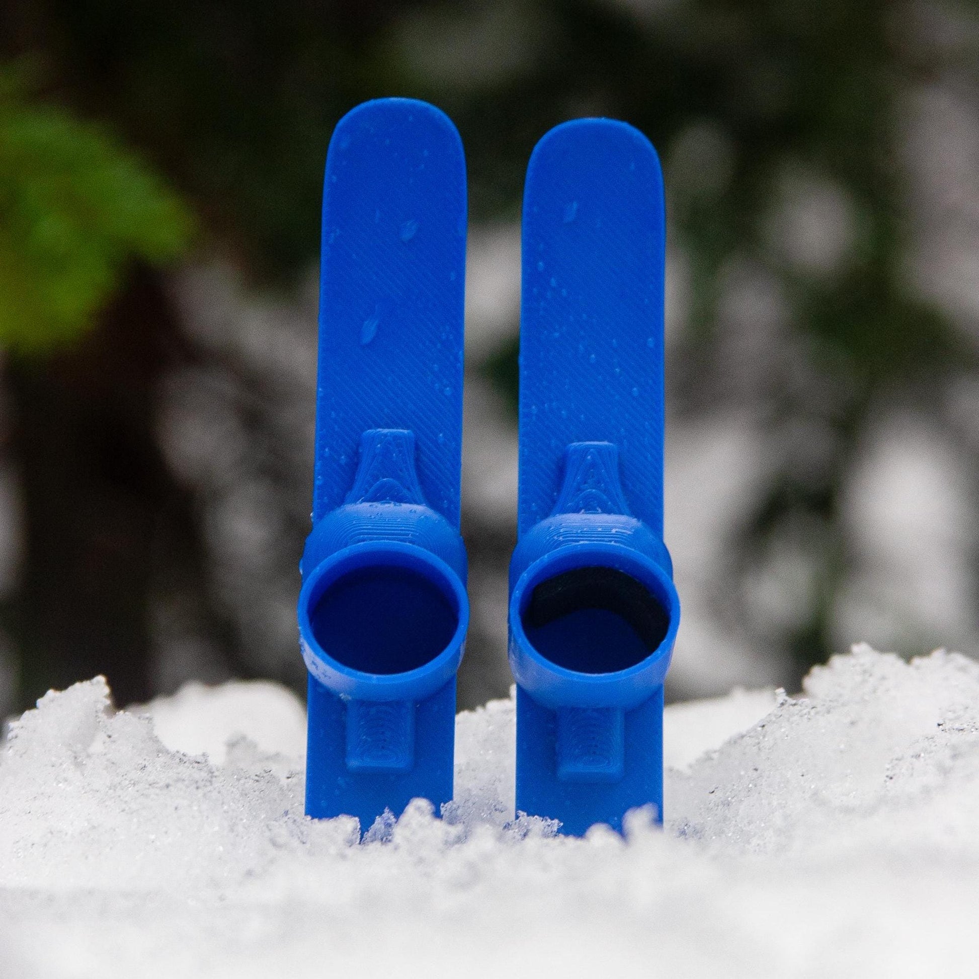 SlideofHand Finger Skis Blue sitting in snow with trees in background
