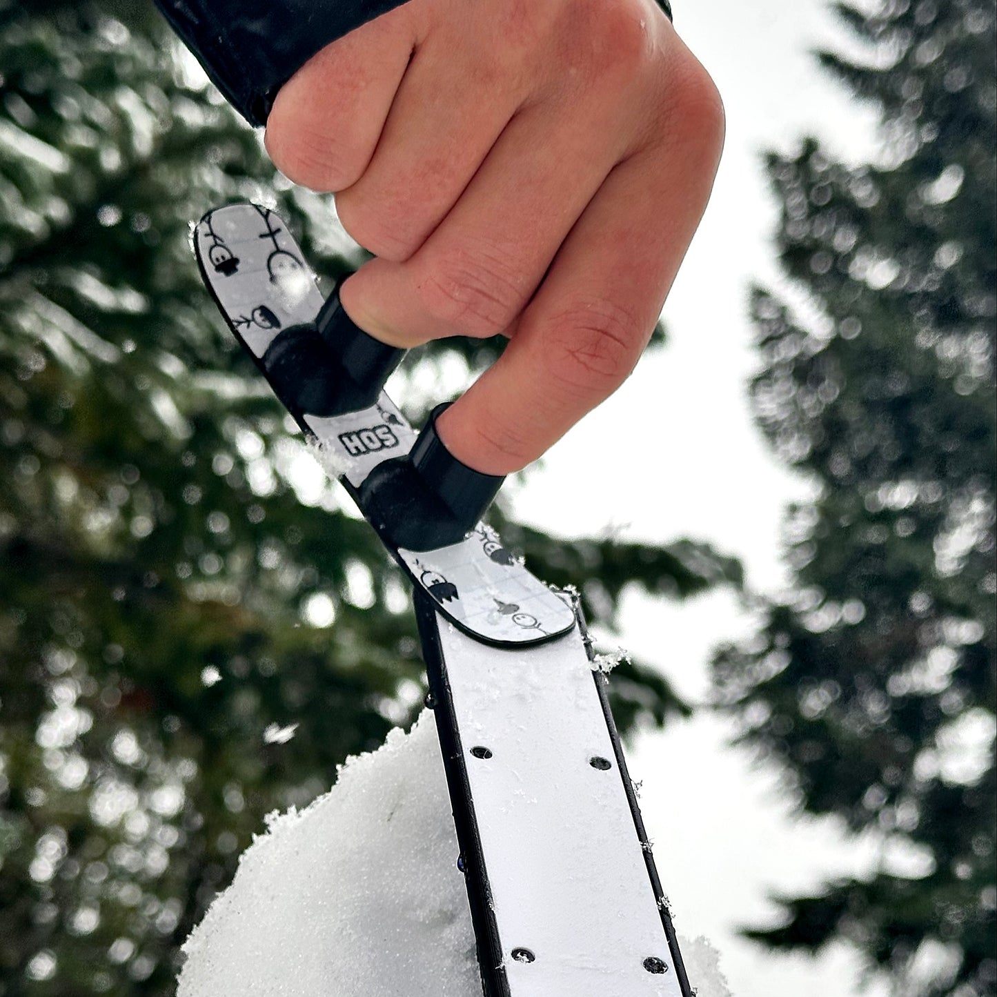 SlideofHand Finger snowboard doodle  Graphic top down hitting a box rail up in the air with trees in the background