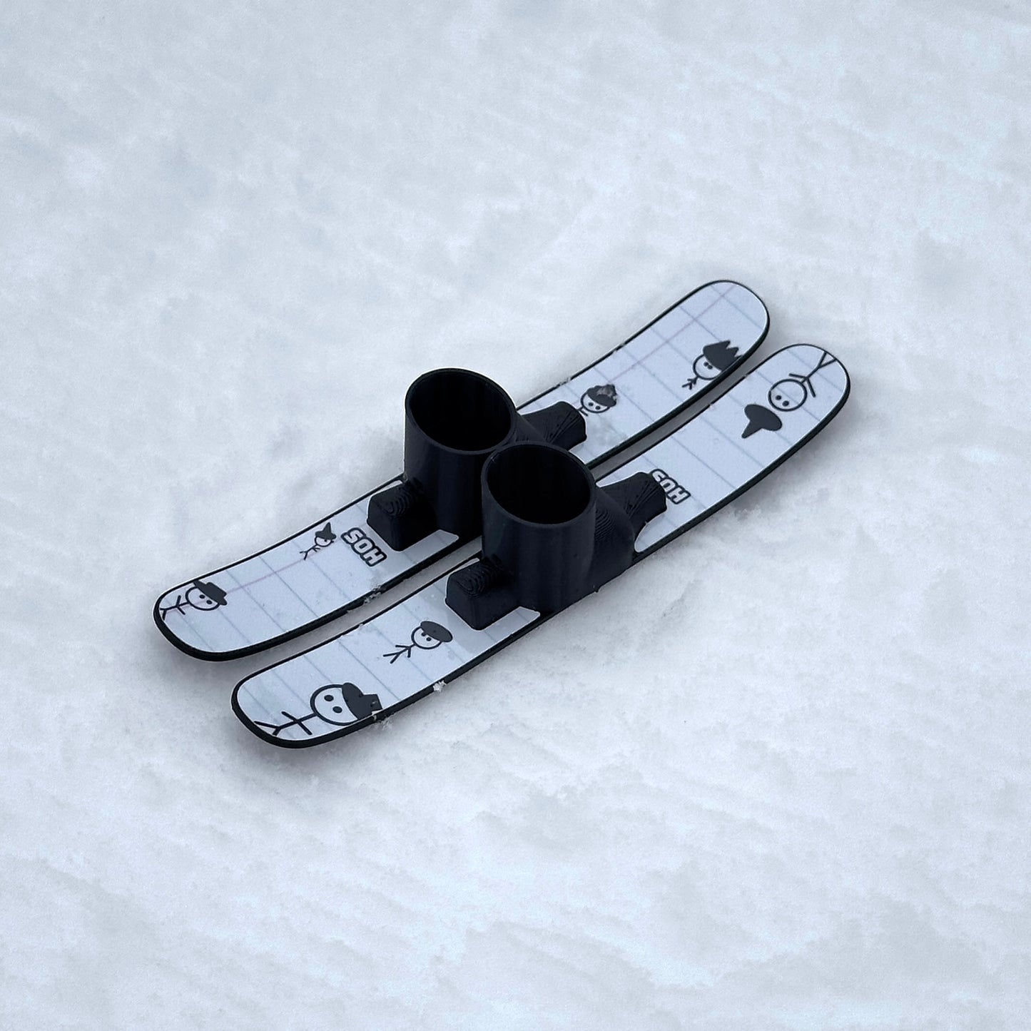 SlideofHand Finger Skis Doodle Graphic top down on a white snowy background