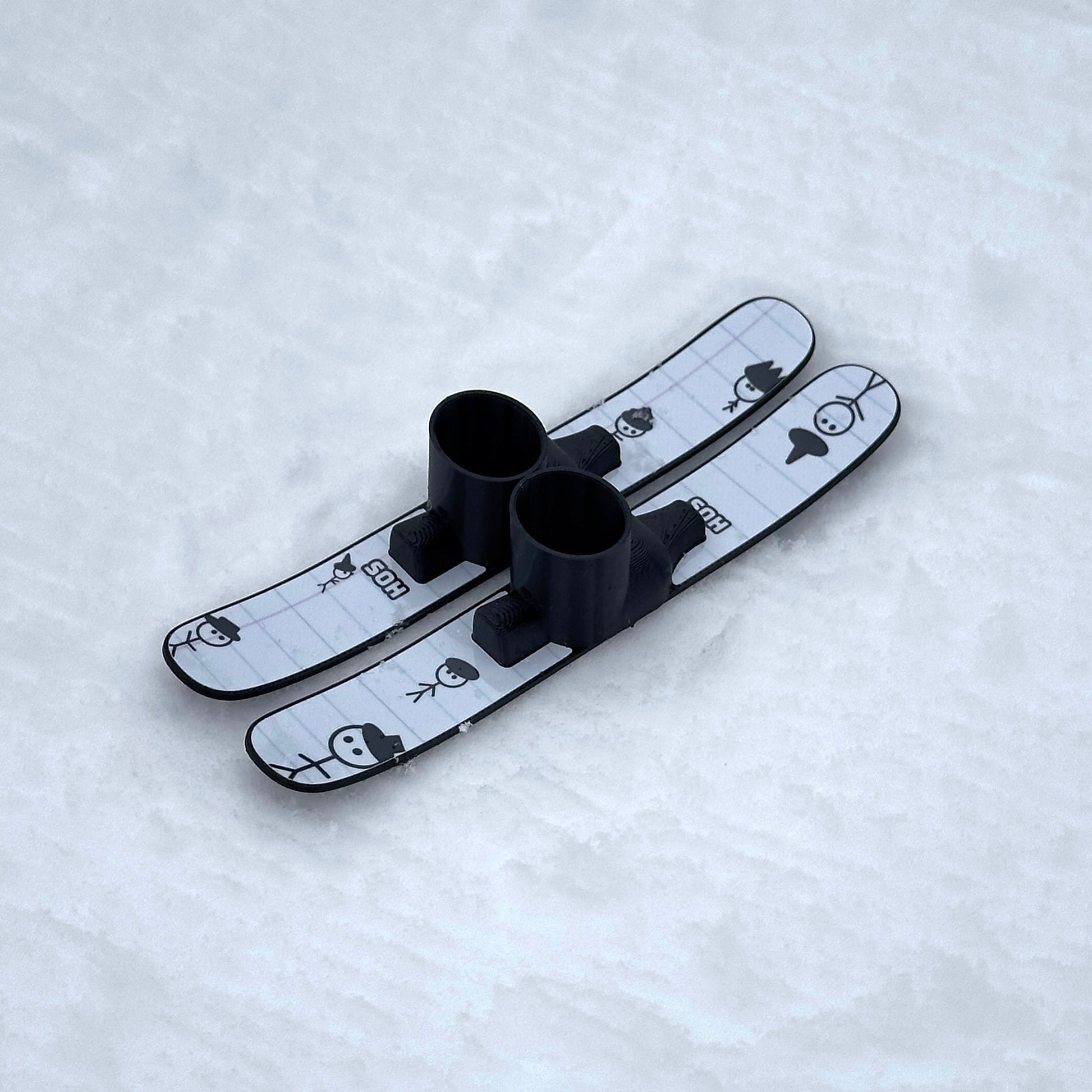 SlideofHand Finger Skis Doodle Graphic top down on a white snowy background