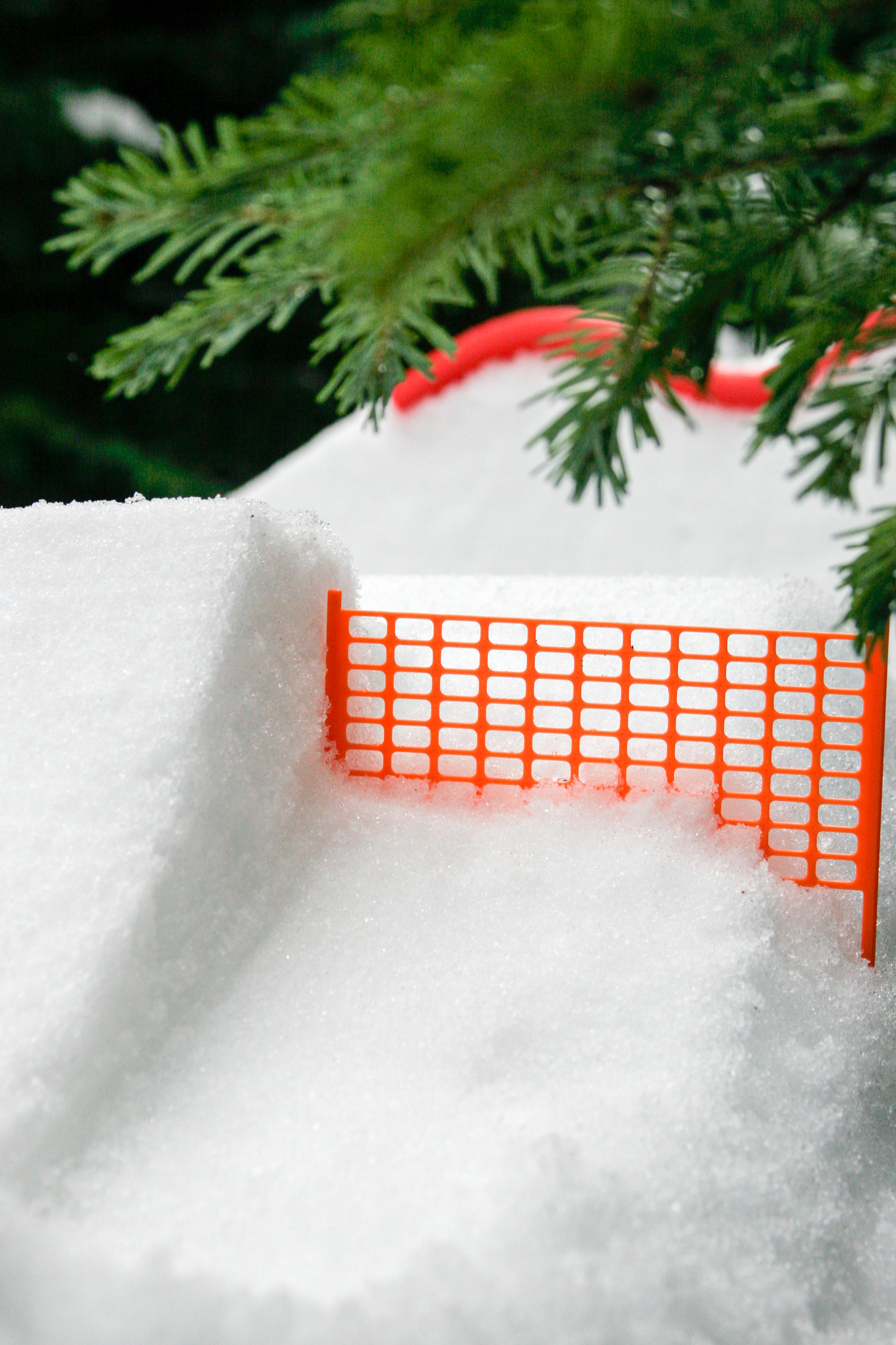 slideofhand safety fencing for finger skis in the snow next to a jump